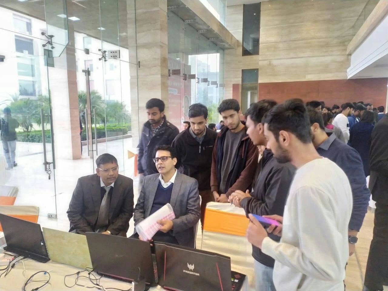 Evaluators and students reviewing a project